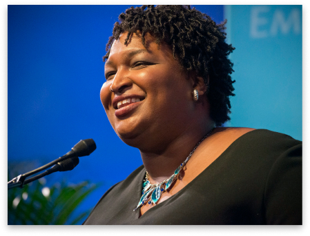 Stacey Abrams speaking into a microphone at the 2019 We are Emily Gala.