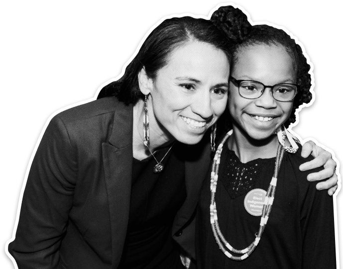 Sharice Davids at the 2019 Historic Firsts Reception, posing with a young supporter.