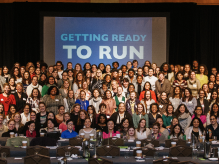 A group picture featuring several Emily's List candidates, with a banner in the background stating "GETTING READY TO RUN."